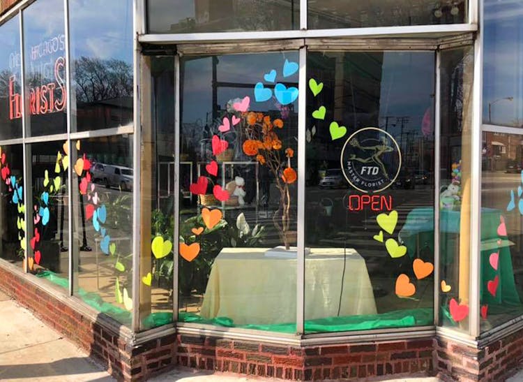 Colorful hand-made hearts decorate the front window of our Chicago storefront