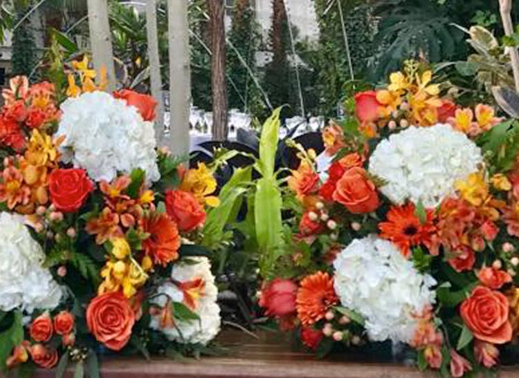 Twin orange, yellow and white arrangements, as seen at a Chicago corporate event